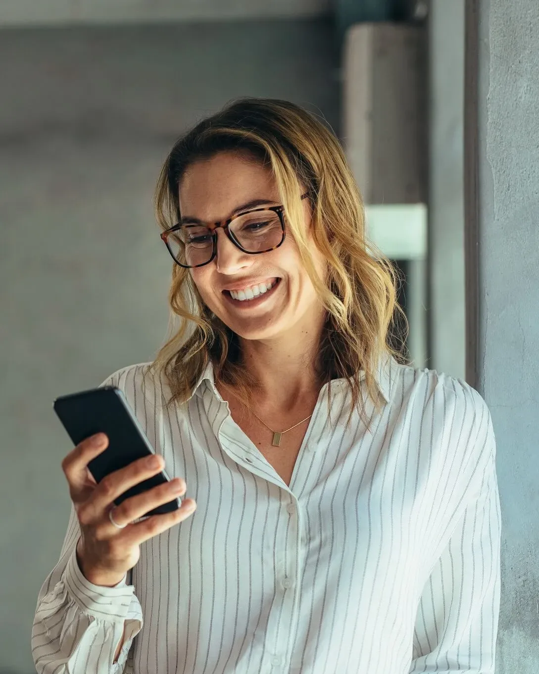 A property owner checking her phone outside her office
